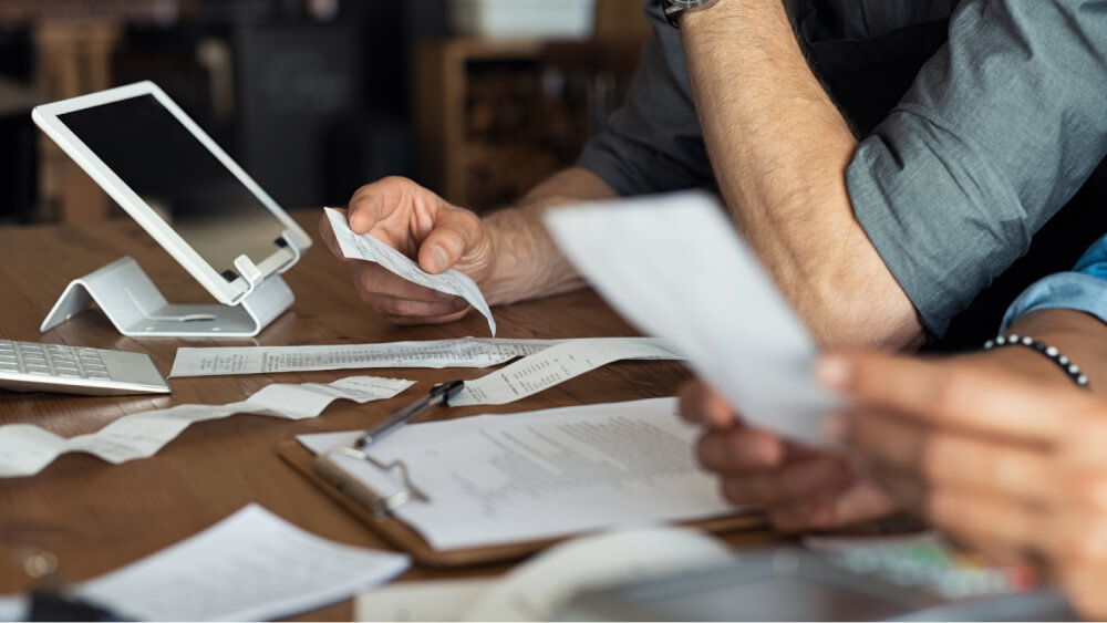 A close-up of a person holding papers