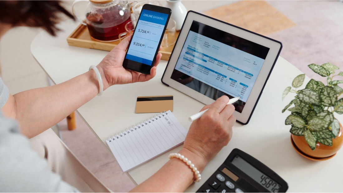 A person using a tablet and a phone