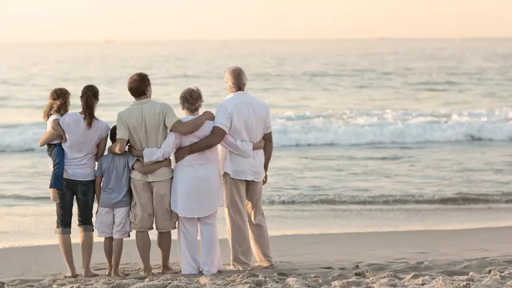 Family Holding each other while at the Beach